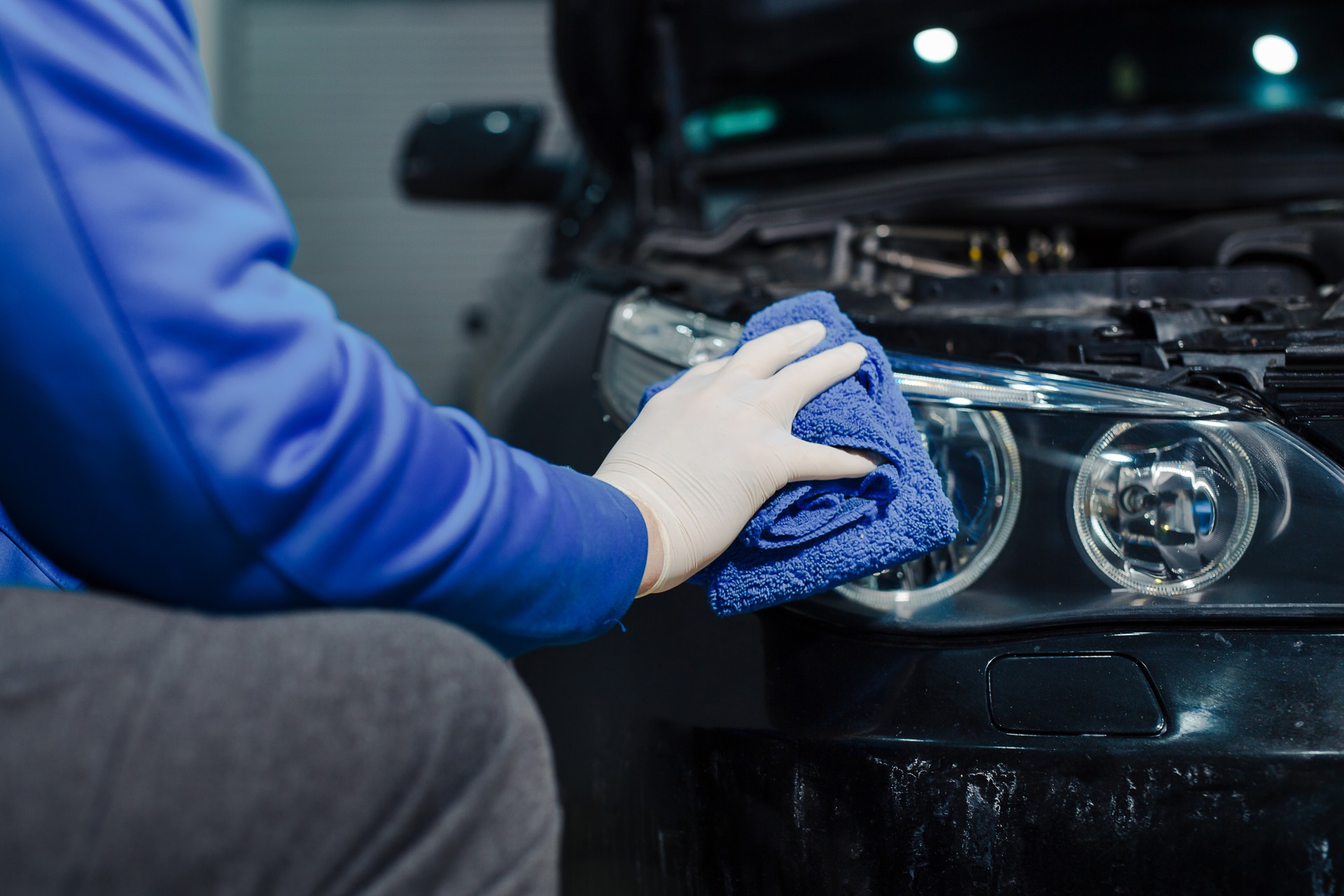 Cleaning headlight with microfiber cloth, car lights